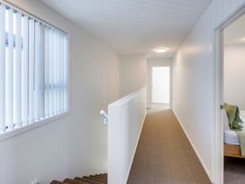 A hallway with a staircase and a window at Mayfair Haven - Hastings Holiday Home, Hastings