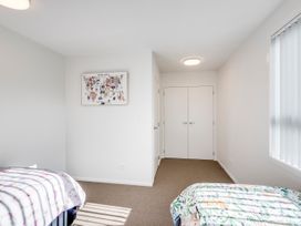 A bedroom with two beds and wall art at Mayfair Haven - Hastings Holiday Home in Hastings
