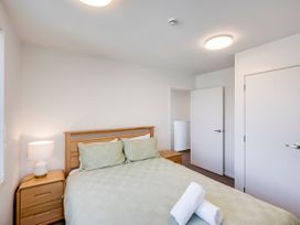 A bedroom with a bed and bedside table at Mayfair Haven - Hastings Holiday Home, Hastings