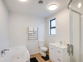 A bathroom with a bathtub, toilet, and sink at Mayfair Haven - Hastings Holiday Home, Hastings