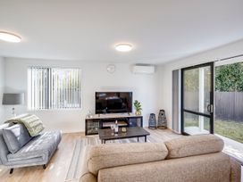 A living room with a television and coffee table at Mayfair Haven - Hastings Holiday Home, Hastings