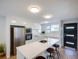 A kitchen with appliances and seating at Mayfair Haven - Hastings Holiday Home, Hastings