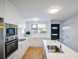 A kitchen with a sink and appliances at Mayfair Haven - Hastings Holiday Home in Hastings
