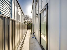 A pathway between two buildings with fences at Mayfair Haven - Hastings Holiday Home, Hastings