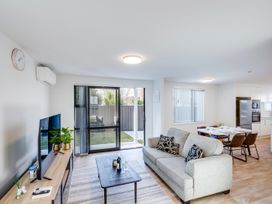 A living room with a sofa and dining area at Mayfair Haven - Hastings Holiday Home Hastings