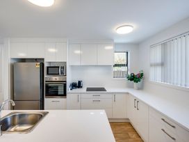 A kitchen with appliances and a sink at Mayfair Haven - Hastings Holiday Home, Hastings