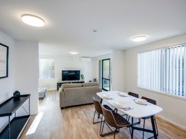 A living room with a sofa and dining table at Mayfair Haven - Hastings Holiday Home Hastings