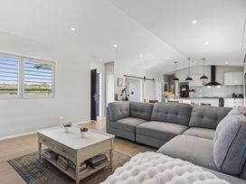 A living room with a sofa and coffee table at Mangawhai Holiday Home Mangawhai