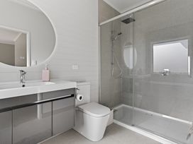 A bathroom with shower and sink at Mangawhai Holiday Home in Mangawhai