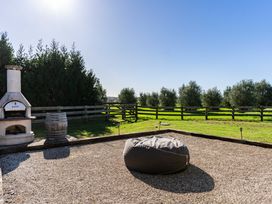An outdoor area with a pizza oven and bean bag at Mangawhai Holiday Home in Mangawhai