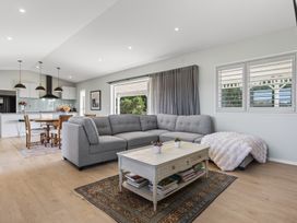 A living room with a sofa and coffee table at Mangawhai Holiday Home in Mangawhai