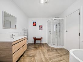 A bathroom with a shower and sink at Martinborough Holiday Home Martinborough
