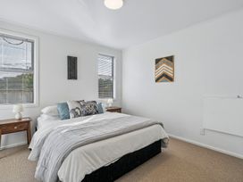 A bedroom with a bed and bedside tables at Martinborough Holiday Home Martinborough