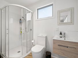 A bathroom with a shower, toilet, and sink at Martinborough Holiday Home in Martinborough