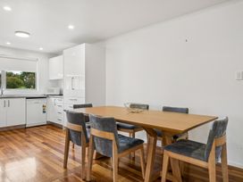 A dining room with a wooden table and chairs at Martinborough Holiday Home in Martinborough