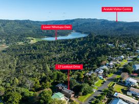 An aerial view showing Lower Nihotupu Dam, Arataki Visitor Centre, and residential area at Roberts Retreat - Auckland Holiday Home, Laingholm
