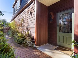 An entrance with a door and pathway at Roberts Retreat - Auckland Holiday Home Laingholm