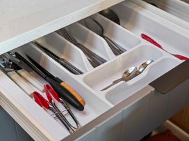 A drawer with cutlery and kitchen tools at Roberts Retreat - Auckland Holiday Home in Laingholm