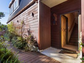 An entrance with a door and steps at Roberts Retreat - Auckland Holiday Home Laingholm