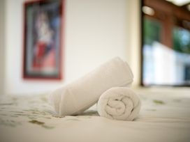 Towels placed on a bed in a bedroom at The Green House