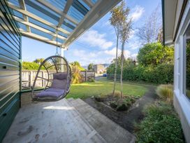 An outdoor area with a hanging chair and grass at The Green House 