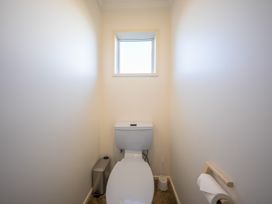 A bathroom with a toilet and window at The Green House 