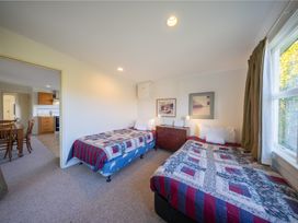 A bedroom with two beds and a dresser at The Green House in 