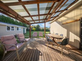 An outdoor patio with a table and chairs at The Green House 