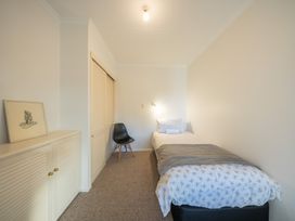 A bedroom with a bed and chair at The Green House 