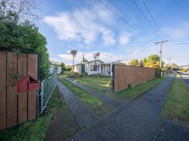 A house with a pathway and fence at The Green House in 