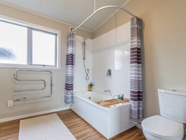 A bathroom with a bathtub and shower at Ohakune Holiday Home in Ohakune