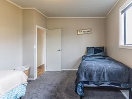 A bedroom with two beds and a door at Ohakune Holiday Home in Ohakune
