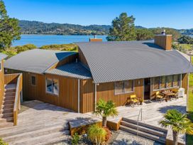 An outdoor area with a deck and seating at Ocean Breeze Family Haven - Pauanui