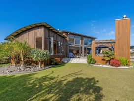 A house with a garden and outdoor seating at Ocean Breeze Family Haven - Pauanui
