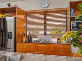 A kitchen with a gas cooker and refrigerator at Ocean Breeze Family Haven - Pauanui