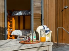 A bedroom with bunk beds and drinks on a table at Ocean Breeze Family Haven - Pauanui