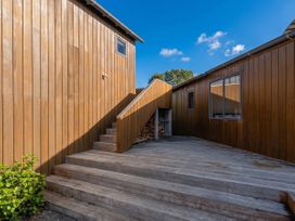 An outdoor area with a staircase and wooden decking at Ocean Breeze Family Haven - Pauanui