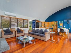 A living room with a sofa and coffee table at Ocean Breeze Family Haven - Pauanui