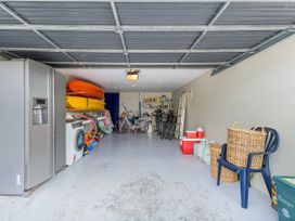 A garage with bicycles and kayaks at Ocean Breeze Family Haven - Pauanui
