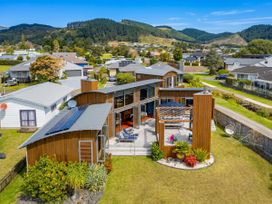 An outdoor area with a deck and garden at Ocean Breeze Family Haven - Pauanui
