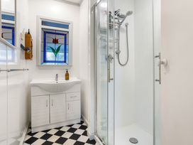 A bathroom with a shower and sink at Tauranga Holiday Home in Tauranga