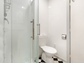 A bathroom with a shower and toilet at Tauranga Holiday Home in Tauranga