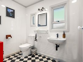 A bathroom with a toilet and sink at Tauranga Holiday Home in Tauranga