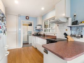 A kitchen with countertops and appliances at Tauranga Holiday Home in Tauranga