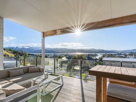 An outdoor area with seating and a view at Panorama View Retreat - Bachcare Holiday Home, Pauanui