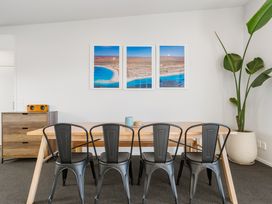 A dining room with a table and chairs at Panorama View Retreat - Bachcare Holiday Home Pauanui