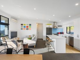 A living room with a sofa and television at Panorama View Retreat - Bachcare Holiday Home in Pauanui