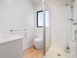 A bathroom with a shower and toilet at Panorama View Retreat - Bachcare Holiday Home, Pauanui
