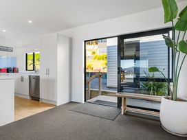 A kitchen with a door leading outside at Panorama View Retreat - Bachcare Holiday Home Pauanui