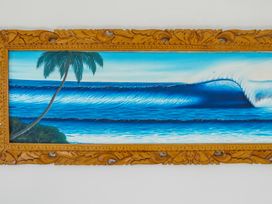 A painting of a wave and palm tree at Panorama View Retreat - Bachcare Holiday Home Pauanui